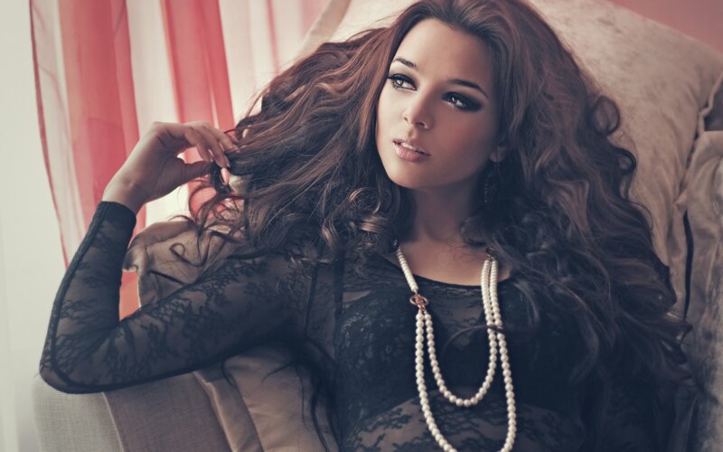 woman with long hair and pearls