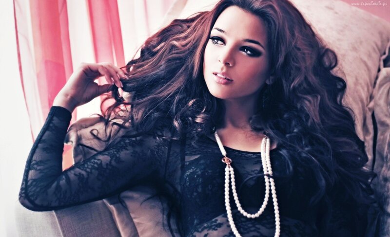 woman with long hair and pearls