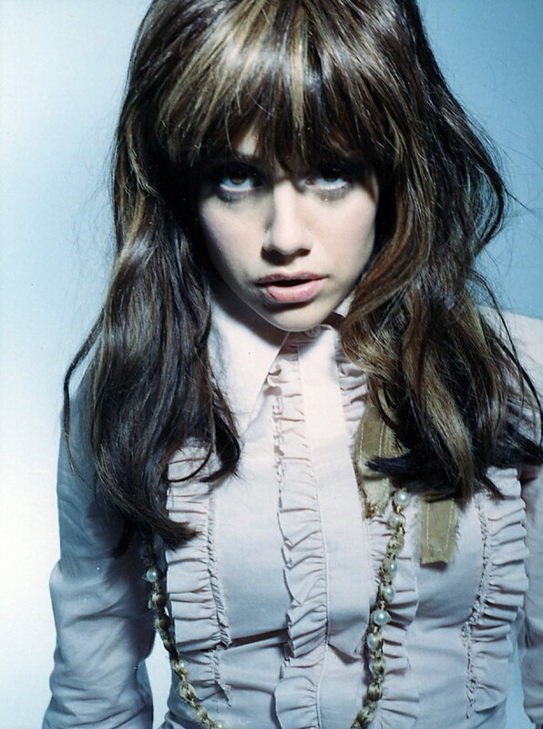 woman with long hair and ruffled shirt
