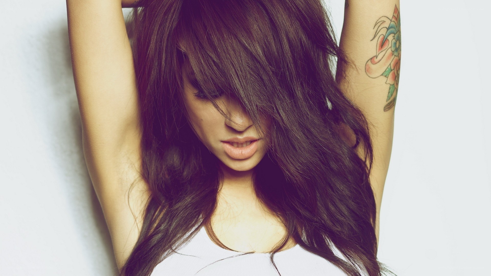 woman with long hair and tattoo