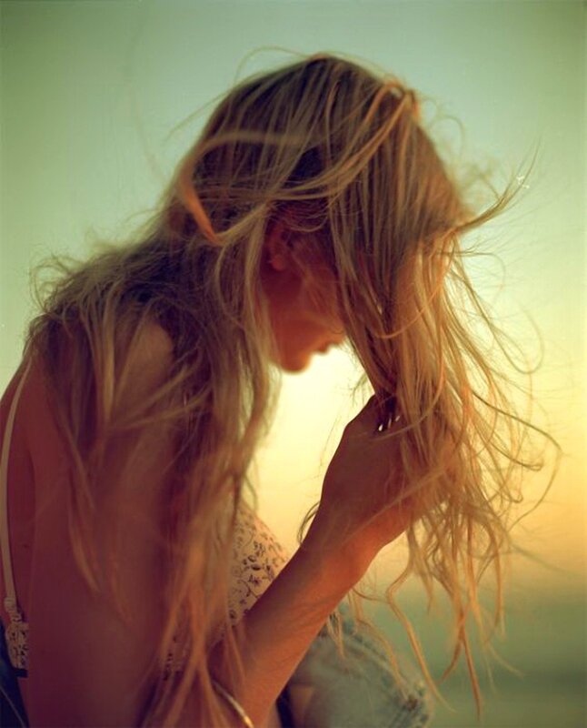 woman with long hair at sunset