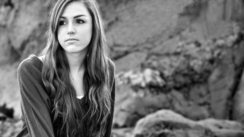 Woman with Long Hair — Black, Serious, Photograph, Rocks