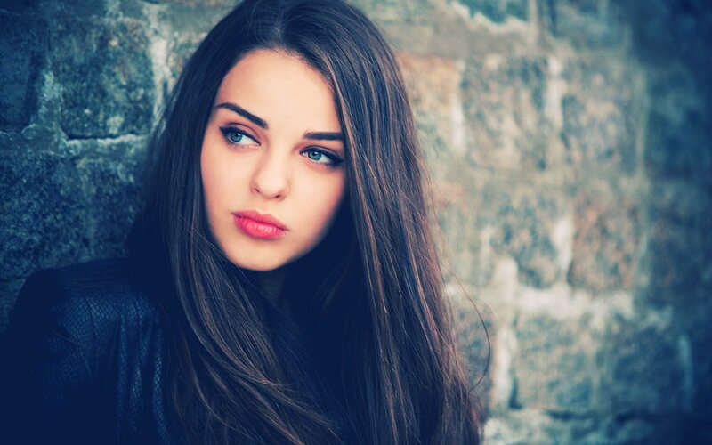 Woman with Long Hair — Blue, Serious, Photograph, Stone Wall