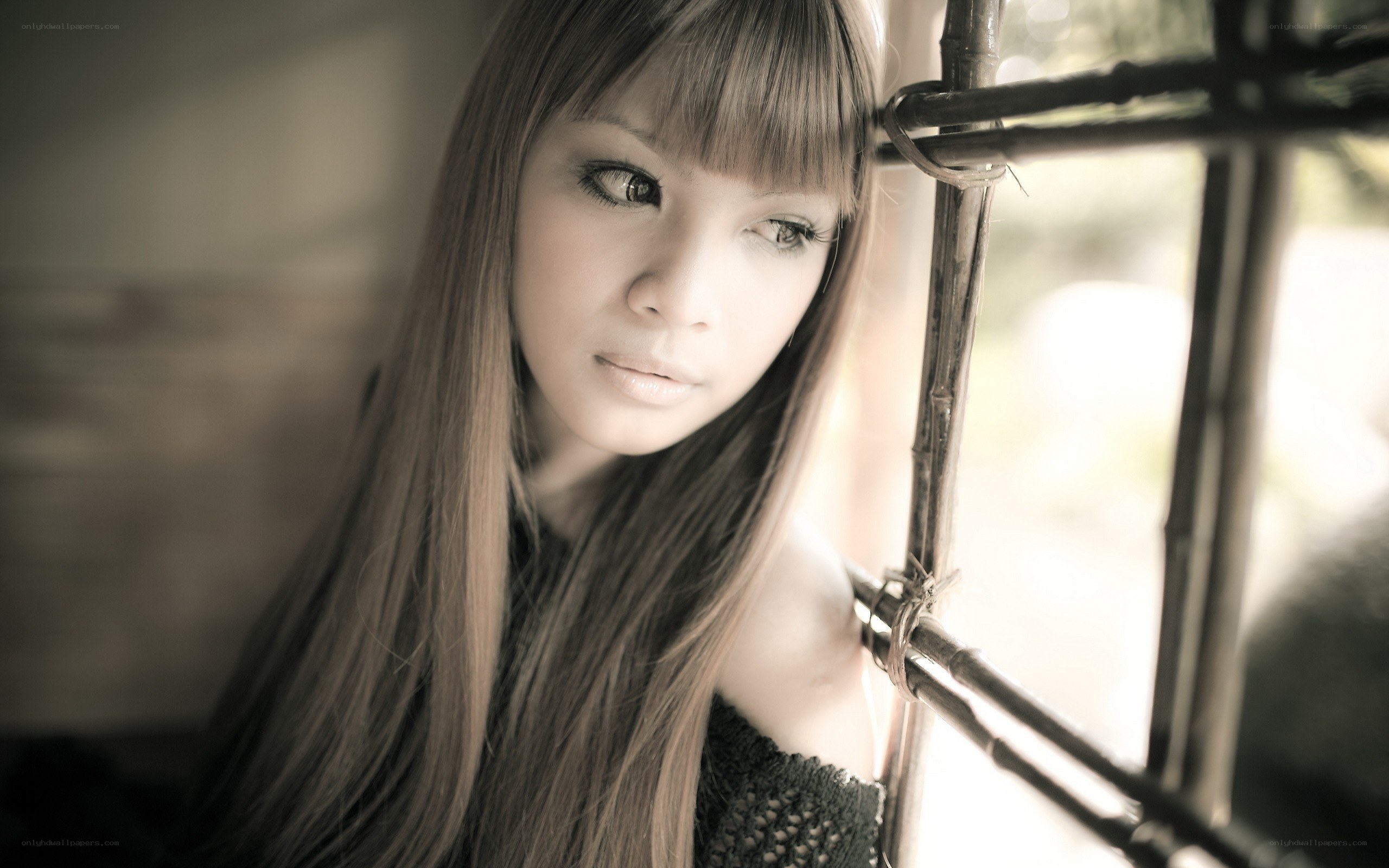 woman with long hair by window