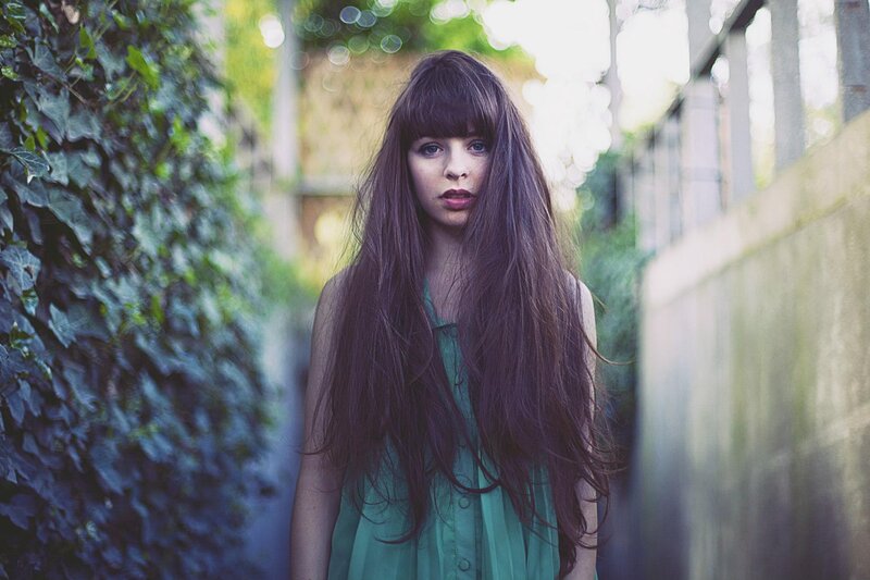 woman with long hair in alley