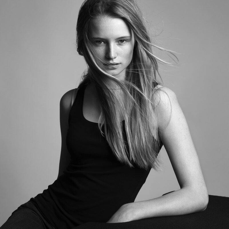 woman with long hair in black top