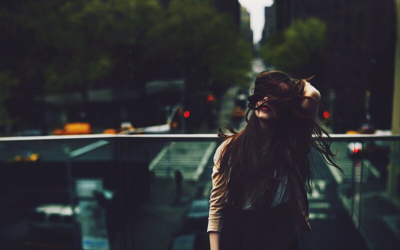 woman with long hair in city