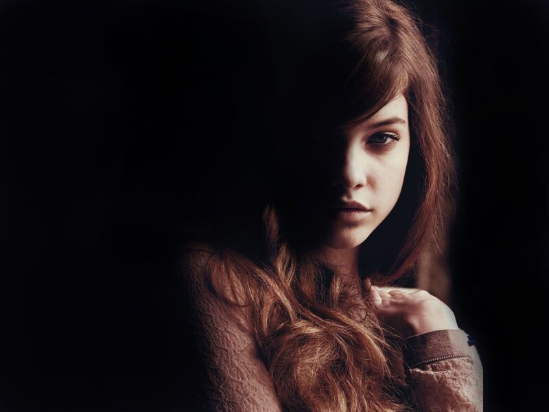 woman with long hair in dark setting