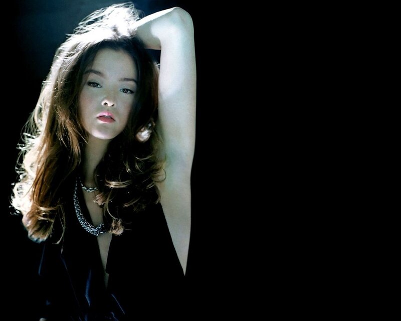 woman with long hair in dark setting