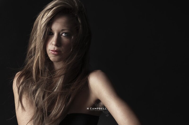 woman with long hair in dark studio