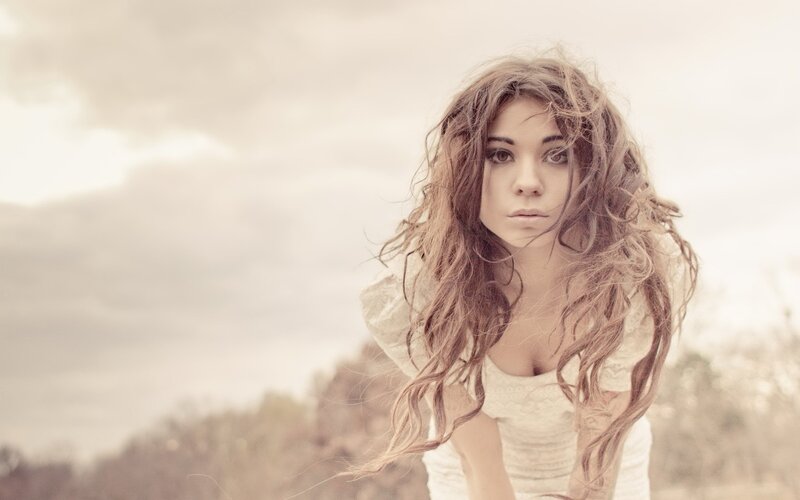 woman with long hair in field