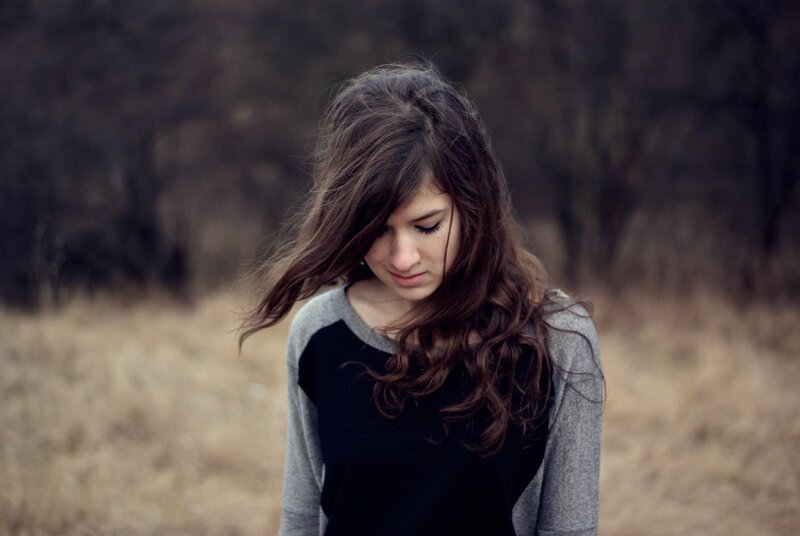 woman with long hair in field