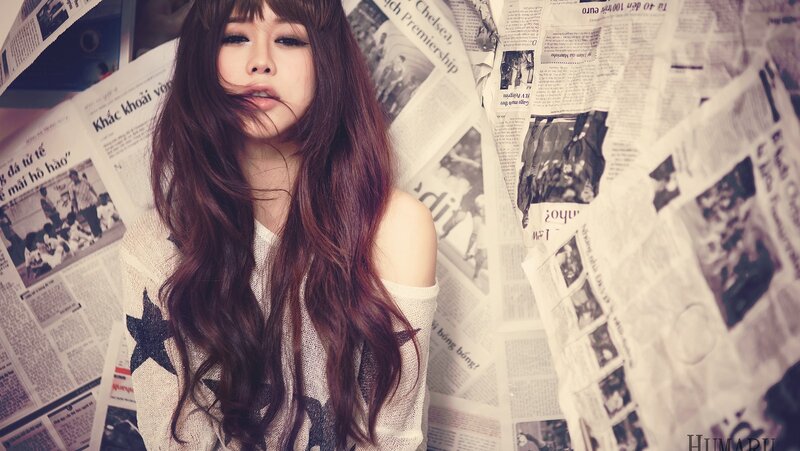 woman with long hair in newspaper room