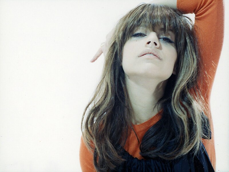 woman with long hair in orange shirt