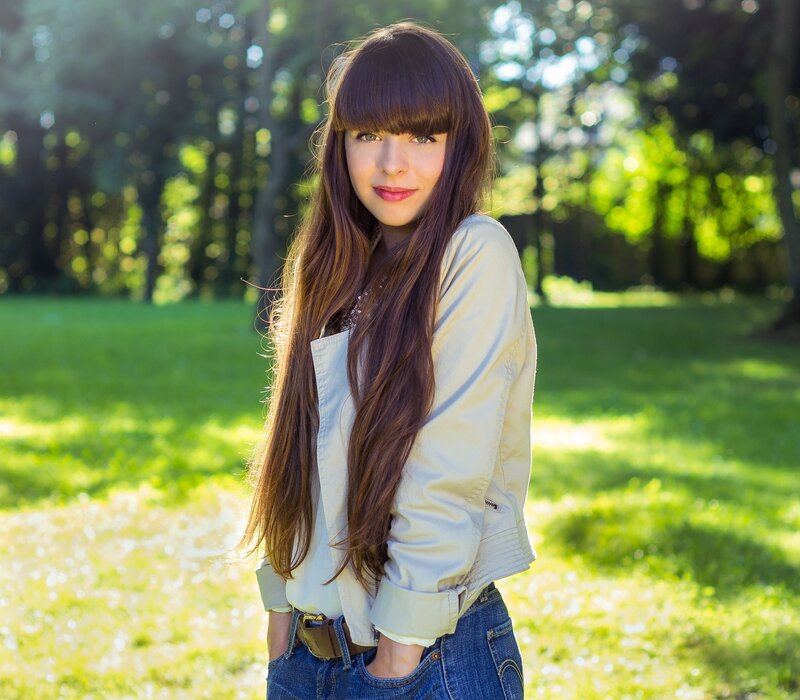 woman with long hair in park