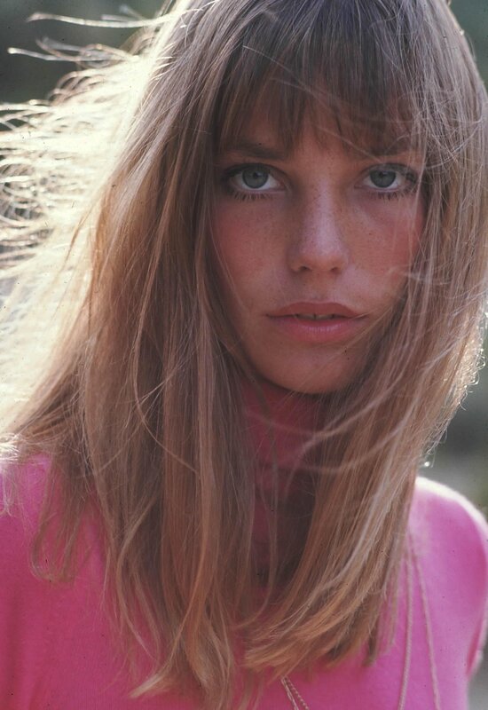 woman with long hair in pink sweater