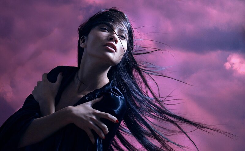 woman with long hair in purple sky