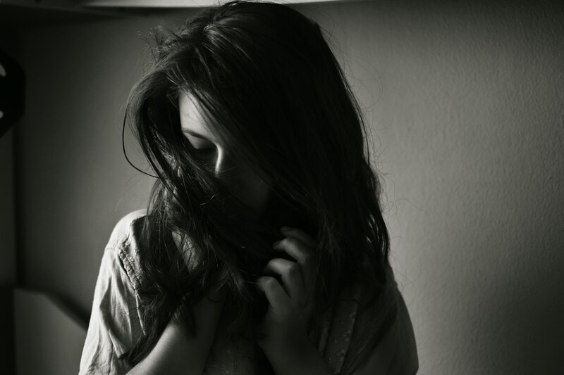 woman with long hair in shadow