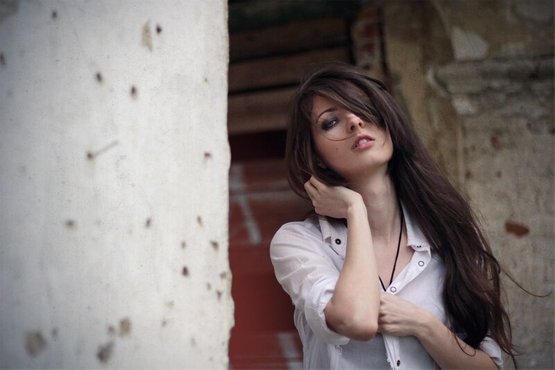 woman with long hair in white shirt