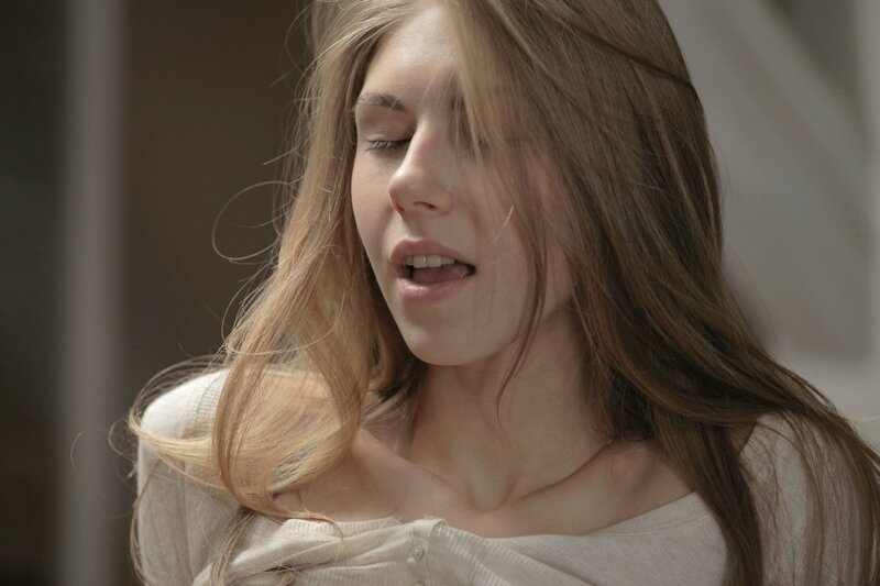woman with long hair in white shirt