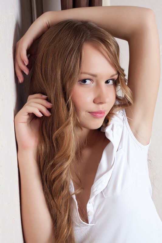 woman with long hair in white shirt