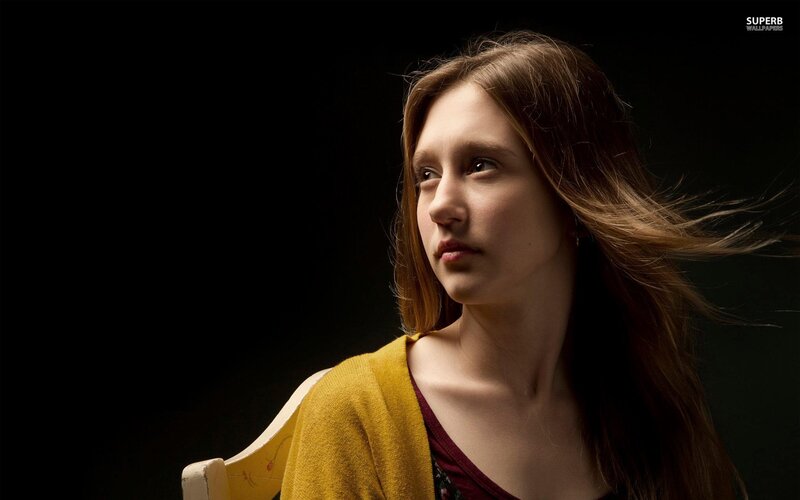 woman with long hair in yellow sweater