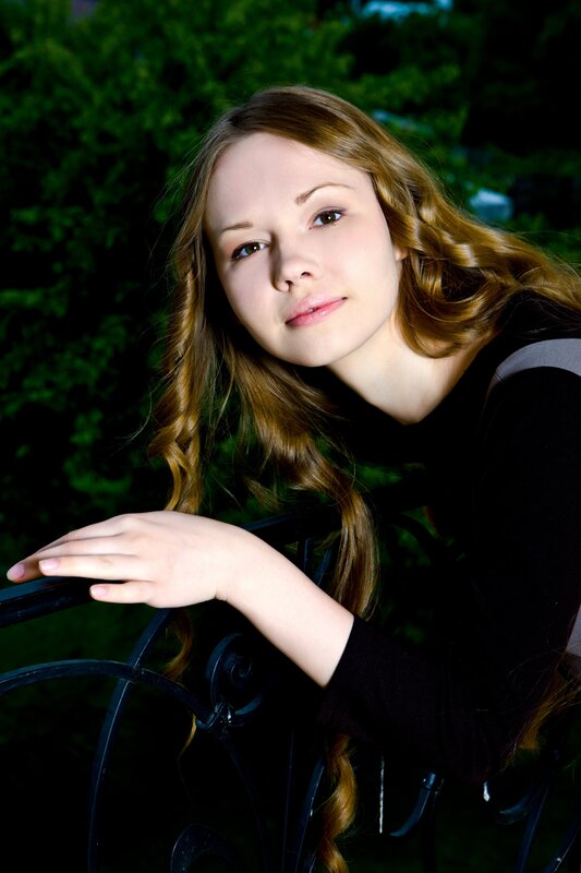 woman with long hair leaning on railing