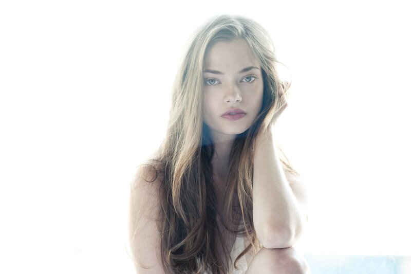 woman with long hair looking at camera