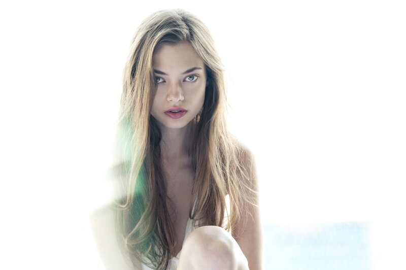 woman with long hair looking at camera