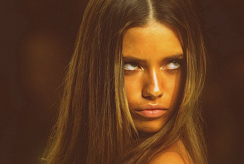 woman with long hair looking at camera