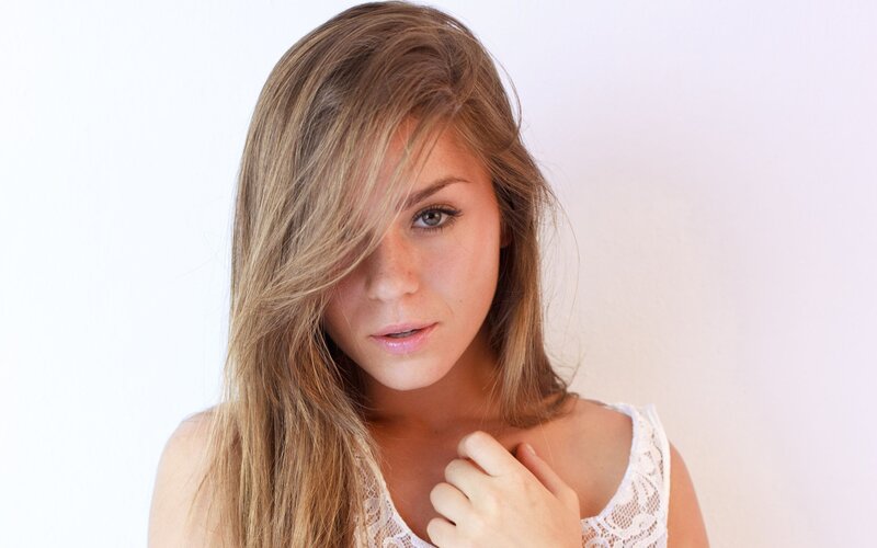 woman with long hair looking at camera