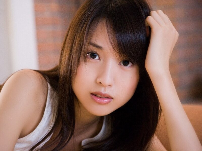 woman with long hair looking at camera