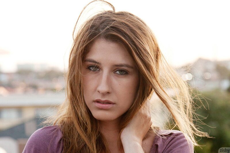 woman with long hair looking at camera