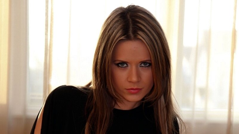 woman with long hair looking at camera