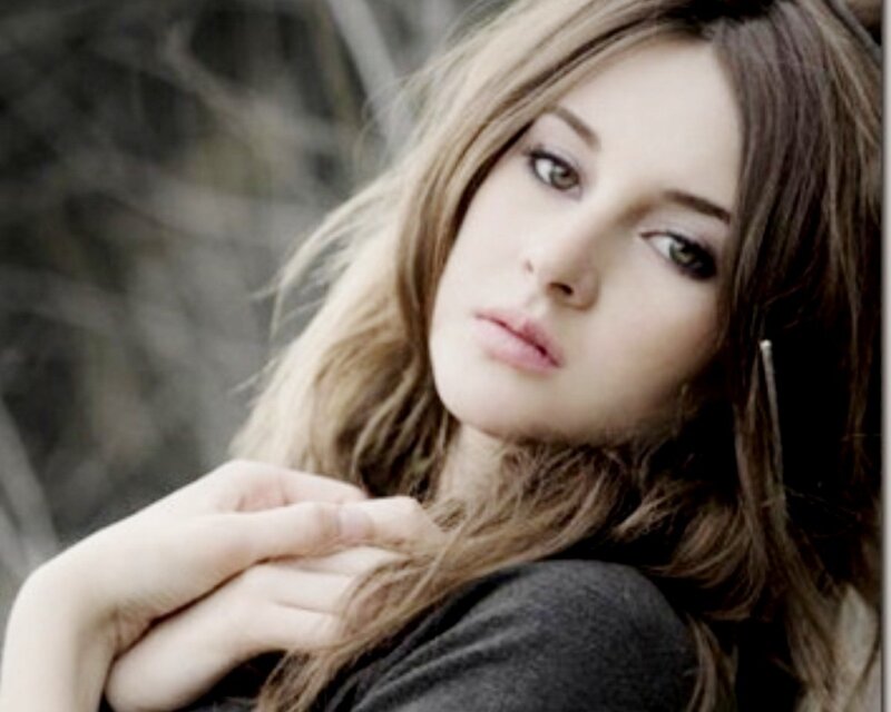 woman with long hair looking at camera