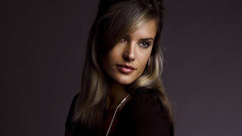 woman with long hair looking at camera