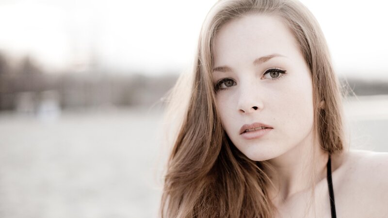 woman with long hair looking at camera