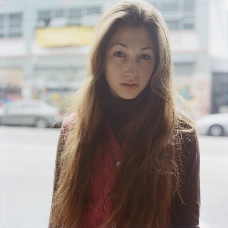 woman with long hair looking at camera