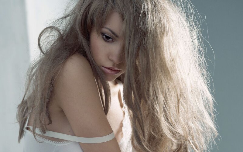 woman with long hair looking down