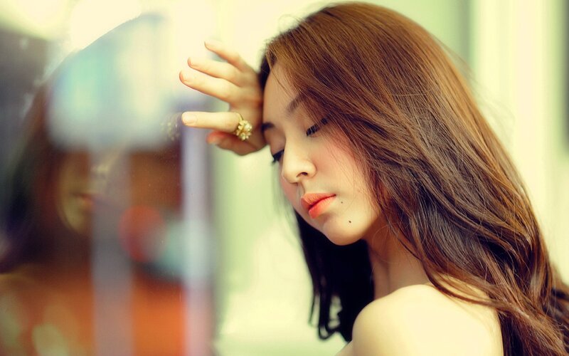 woman with long hair looking down