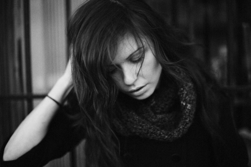 woman with long hair looking down