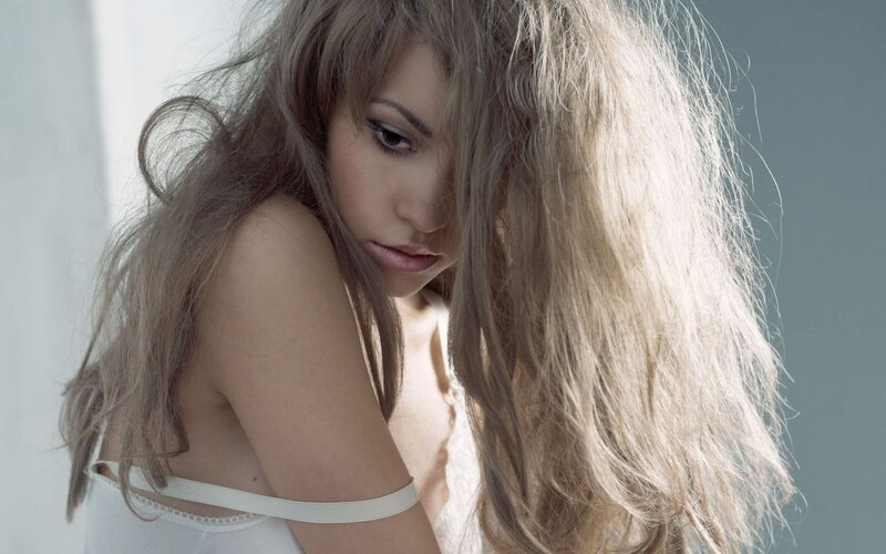 woman with long hair looking down