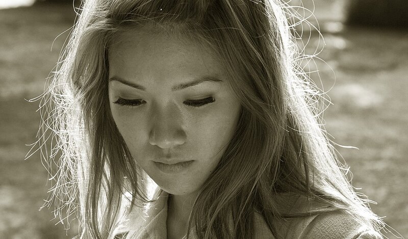 woman with long hair looking down