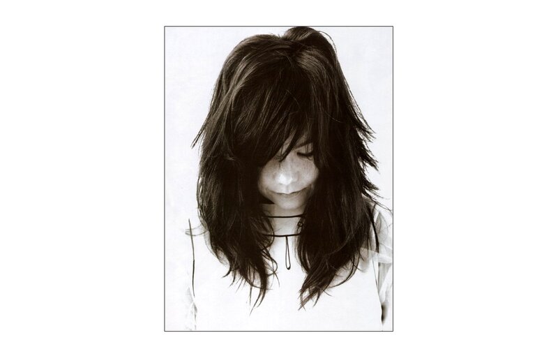 woman with long hair looking down