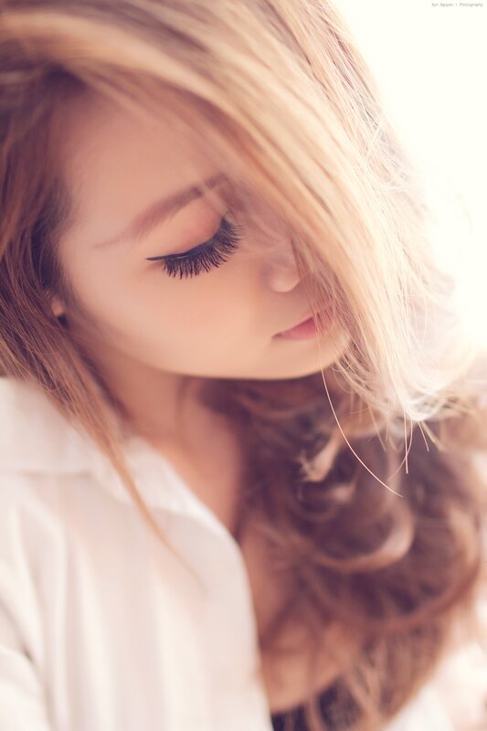 woman with long hair looking down
