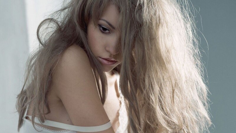 woman with long hair looking down