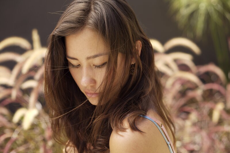 woman with long hair looking down