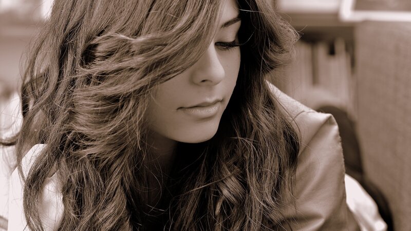 woman with long hair looking down
