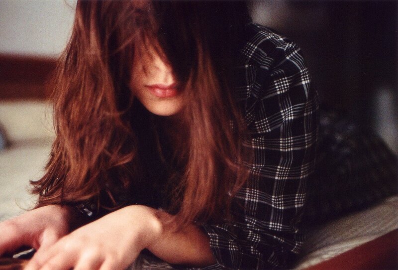 woman with long hair looking down