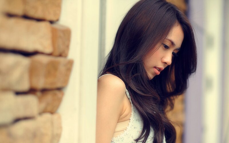 woman with long hair looking down